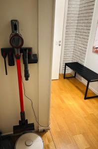 a red vacuum in a room with a table at Strandveien apartment in Narvik