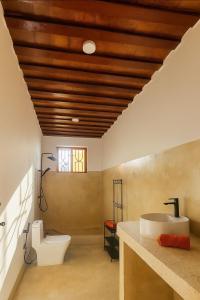 a bathroom with a white toilet and a sink at Villa-Katerima-paje zanzibar in Kiganga +13 photos
