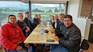 a group of people sitting at a long table at La Maison d'Urbina in Chimborazo +23 photos
