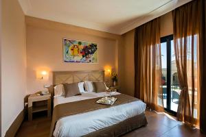 Postel nebo postele na pokoji v ubytování Mahara Hotel & Wellness
