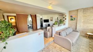 a living room with a couch and a tv at Casa Bella Fruška Gora with HOT TUB in Velika Remeta