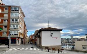 a building with a sign on it on a city street at Castro Romano VUT 7712 AS in Gijón