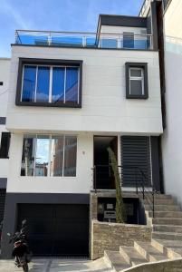 a house with a scooter parked in front of it at Spa house with private Jacuzzi in Dosquebradas - Pereira in Dosquebradas