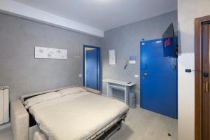 a bedroom with a bed and a blue door at Sweetie Tuscany House in Montecatini Terme