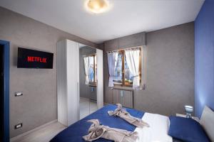 a bedroom with a blue bed with towels on it at Sweetie Tuscany House in Montecatini Terme