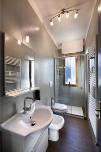 a bathroom with a sink and a toilet and a shower at Sweetie Tuscany House in Montecatini Terme
