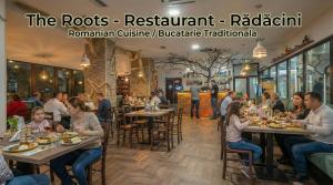 a group of people sitting at tables in a restaurant at Uni88 Apart Hotel in Bucharest