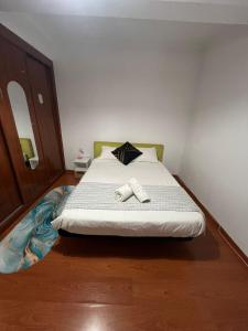a bedroom with a bed with two towels on it at Geovanny house in Funchal