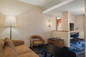 a living room with a couch and a table at Fairfield Inn & Suites by Marriott Cumberland in Cumberland