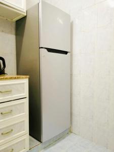 a refrigerator in the corner of a kitchen at Terhal guest house in Muscat