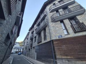 a building with balconies on the side of a street at El Rincón de Escarrilla in Escarrilla