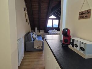 a kitchen with a counter and a living room at El Rincón de Escarrilla in Escarrilla