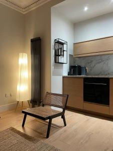 a living room with a coffee table and a kitchen at Cosy Coastal getaway 2 bed flat in Largs in Largs