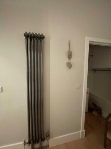 a radiator in the corner of a room at Cosy Coastal getaway 2 bed flat in Largs in Largs