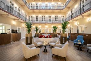 a large lobby with couches and chairs at BasiliQ Hotel in Budapest