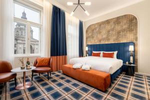 a hotel room with a bed and a table and chairs at BasiliQ Hotel in Budapest