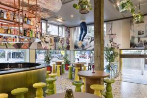 a restaurant with yellow stools and a bar at JO&JOE Auckland in Auckland