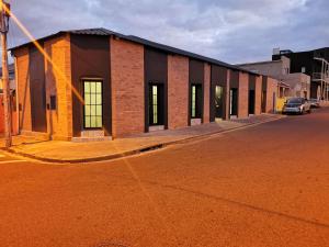 a brick building on the side of a street at Modern Boho Loft- Observatory in Cape Town +7 photos
