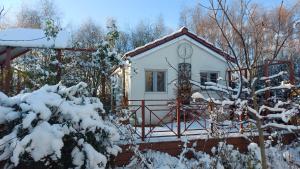 a small white house with snow on it at Apartmány U Obory in Nechánice