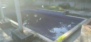 a pool of water in a yard with at Estância do atash in Santa Leopoldina +8 photos