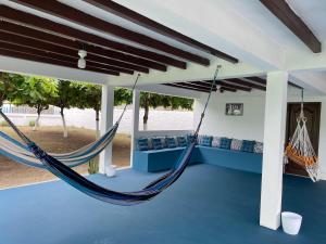 a hammock in the living room of a house at Villa Solara - A Beachfront Residence in San Clemente