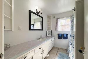 a bathroom with a sink and a mirror at The Updated Aviator - Minutes to Everything Wichita Falls, TX in Wichita Falls