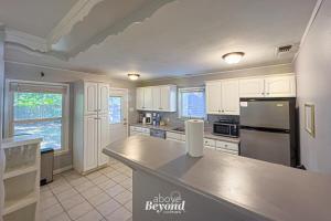 a kitchen with white cabinets and a stainless steel refrigerator at The Updated Aviator - Minutes to Everything Wichita Falls, TX in Wichita Falls +34 photos