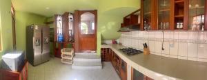 a kitchen with green walls and a refrigerator at Shumaq Guesthouse in Carhuaz +46 photos