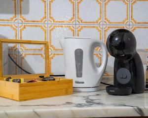 a coffee maker and a cup on a counter at I Cuculi vacation home in Lucca in Lucca