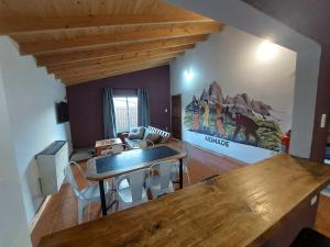 a kitchen with a wooden table and a dining room at Nomade bedbox Hostel in El Chalten