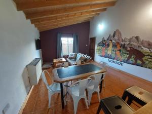 a dining room with a table and some chairs at Nomade bedbox Hostel in El Chalten +5 photos
