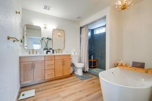 a bathroom with a tub and a toilet and a sink at 2 Mi to Dtwn Gorgeous Gilbert Gem with Private Yard in Gilbert +19 photos