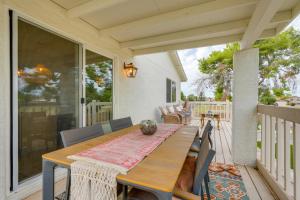 a wooden table and chairs on a porch at 2 Mi to Dtwn Gorgeous Gilbert Gem with Private Yard in Gilbert