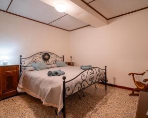 a bedroom with a bed and a wooden dresser at I Cuculi vacation home in Lucca in Lucca +48 photos