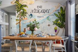 a dining room with a table and a mural at NEW!The HideawayPoolPickleballPutt-PuttKayaks! in Marathon
