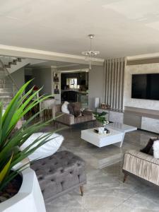 a living room with a couch and a table at ALIMU villa Mbombela in Nelspruit