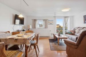 a living room with a table and a couch at Calm Holiday Home With Great Outings in Kollund