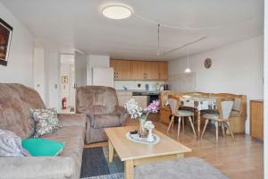 a living room with a couch and a table at Calm Holiday Home With Great Outings in Kollund