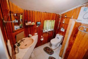 a small bathroom with a toilet and a sink at Classic, Cozy House for Transient in Baguio City 1 in Baguio +86 photos
