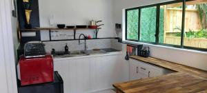 a kitchen with a sink and a window at Darwin Cottage in Kerikeri