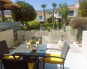 a patio with a table and chairs on a patio at Summer Forever townhouse in Peyia +23 photos