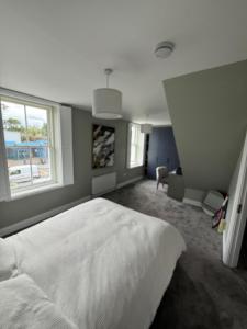 a bedroom with a white bed and a window at 4 bedroom house sleeps 8 next to Aviva Stadium and Landsdown Stadium in Dublin