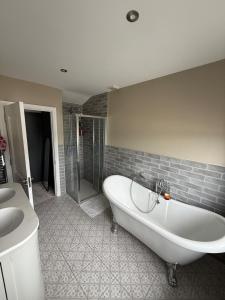 a bathroom with a tub and a shower and a sink at 4 bedroom house sleeps 8 next to Aviva Stadium and Landsdown Stadium in Dublin +13 photos