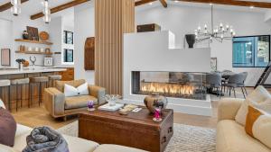 a living room with a fireplace and a kitchen at Crescendo Crest in Steamboat Springs +40 photos