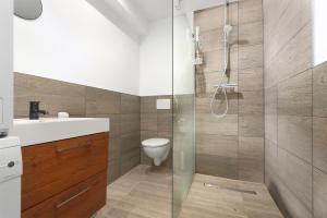 a bathroom with a toilet and a glass shower at Apartment A66 in Gründau