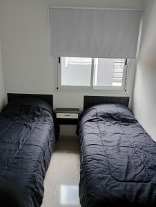 Ένα ή περισσότερα κρεβάτια σε δωμάτιο στο Jhordan II San Bernardo