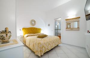 a bedroom with a bed with a yellow head board at La Dolce Vita Ravello - Exclusive Family & Group Villa with 4 Apartments, 5 Bedrooms in Ravello