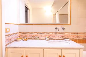a bathroom with a sink and a mirror at La Dolce Vita Ravello - Exclusive Family & Group Villa with 4 Apartments, 5 Bedrooms in Ravello +59 photos