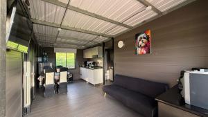 a living room with a couch and a painting of a dog at Cabaña Susurro de Susata in Nemocón