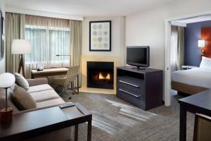a hotel room with a couch and a fireplace at Sonesta ES Suites Atlanta Alpharetta Windward in Alpharetta